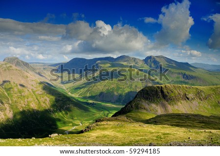 English Lake District mountains in summer. The view from Red Pike over the Mosedale Valley towards Yewbarrow, Great Gable, Kirk Fell and the Scafell Range Royalty-Free Stock Photo #59294185