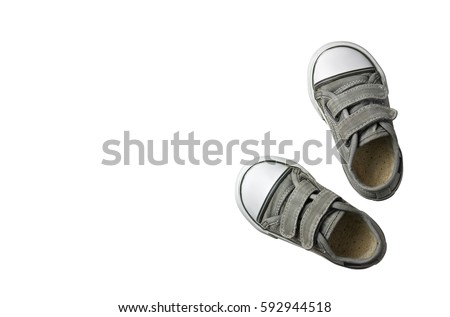 old secondhand black canvas shoes or sneakers for kids or baby and child foot on white background top view with copyspace isolated included clipping path Royalty-Free Stock Photo #592944518