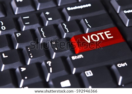 Picture of red button on the computer keyboard with word of vote