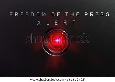 Red glowing warning lamp or button black panel with the words, "FREEDOM OF THE PRESS"?and "Alert".