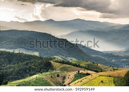rice terrace and hut on the mountain hill with storm cloud and raining
