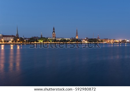 Skyline of Riga seen across the river Daugava after the sunset. Three church towers in the picture are the Riga Dome cathedral,  St. Saviour's Church and St. Peter's church. 