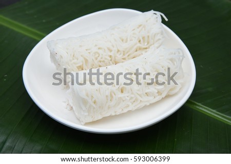 Noolappam/Idiyappam/rice noodles, a popular traditional steam cooked Kerala breakfast dish with hot and spicy roast curry on a houseboat, Alleppey, India. South Indian food. noolputtu Sri lankan