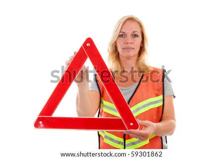 Woman in safety vest holding foldaway reflective road hazard warning triangle over white background
