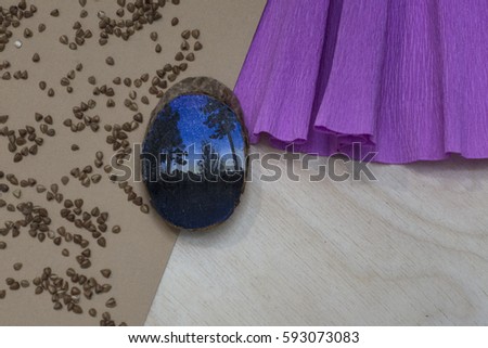 Wooden stump. Beautiful picture blue sky landscape painted on a wooden stump. Paper pink substrate. Buckwheat groats