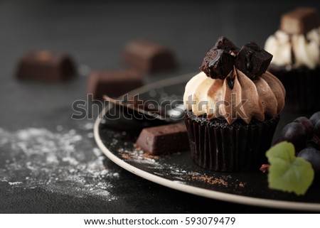 Chocolate cupcake with icing and chocolate bar in Dark lighting, AF point selection.