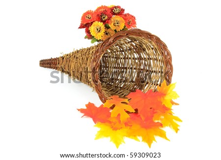 Still picture of decorative wooden basket for Thanksgiving Day and Harvest decorated with Fall leaves and flowers orientated horizontal over white.