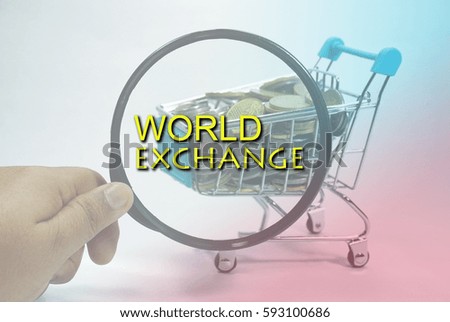 A hand holding a magnifying glass close up with a pile of coins currency of Malaysia  (MYR) in a trolley on isolated white background. A finance, saving and business concept. 