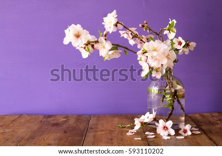 spring bouquet of cherry tree branches on the wooden table