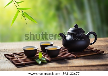 tea cup and teapot on wood plank outside the door Royalty-Free Stock Photo #593133677