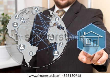 The businessman clicks with web touch home on the touch screen with maps of the world.The concept of finding housing for rent or purchase.  
