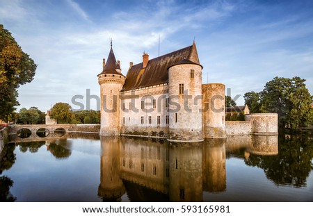 Chateau de Sully-sur-Loire in summer, France. This medieval castle is one of the main landmarks of Loire Valley. Beautiful view of French castle on the water. Idyllic panorama of old castle in quiet.