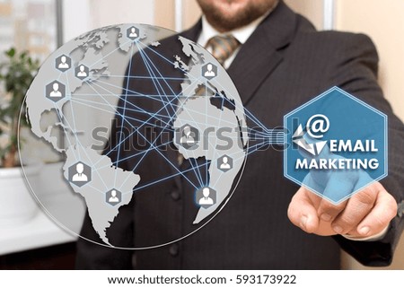 The businessman  clicks the button EMAIL MARKETING on the touch screen in the global network. 