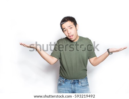 young asian man early adult age shrugged to express doubt, ignorance or indifference with absurd face expression, studio shot white background