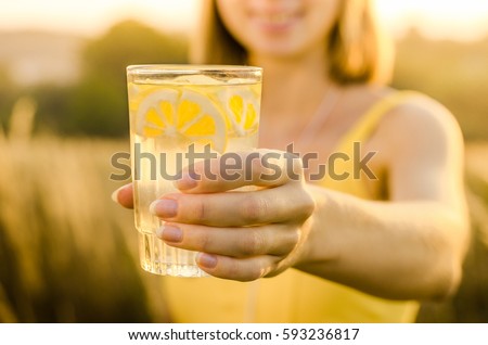 Diet. Healthy eating .Woman hand holding lemonade drink  on the background blurred nature outdoor. Fresh detox vegetable juice. Healthy lifestyle, vegetarian food. Nutrition Concept. Royalty-Free Stock Photo #593236817