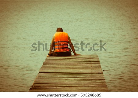 Boy on wooden bridge