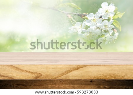 Top wooden table and in the background blurred plants as a theme spa. Empty space to paste and mounting of different products.