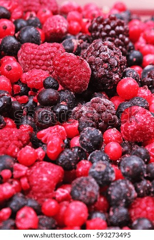 Fruits from wood. Frozen mixed berries as background. Blueberries,raspberries black berries and currant mulberry texture pattern. Stunning fruit berries
