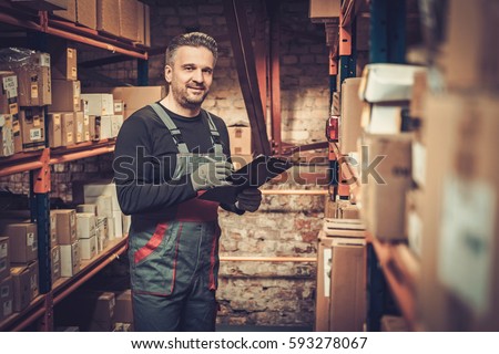 Storekeeper with manual picking list on a warehouse Royalty-Free Stock Photo #593278067