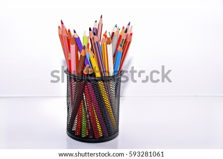 Colored pencils on table. Isolated on white background.