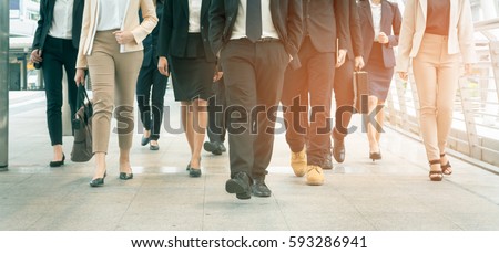 Group of businessman and businesswoman walking in modern city, successful business team. Royalty-Free Stock Photo #593286941