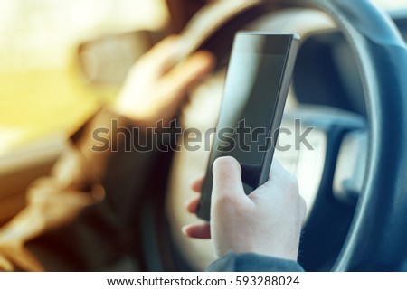 Driving car and using mobile phone to send text message is dangerous behaviour in traffic that could cause accident