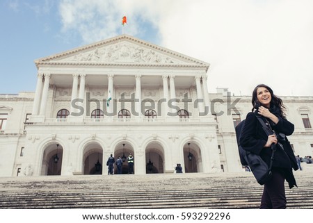 Female tourist standing in front of the Parliament of Portugal,Assembly of the Republic.Beautiful architecture of Assembleia da República.Walking woman visitor admiring São Bento Palace,Lisbon