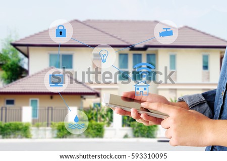 Smart home secured automation with wifi technology, Hand using smartphone as house mobile monitor such as camera, computer, door and light, internet of things, people and smart home concept
 Royalty-Free Stock Photo #593310095