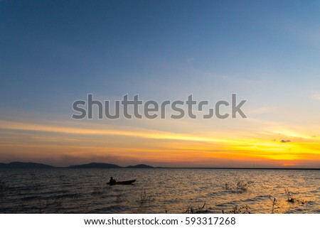 Silhouette of Canoes on the River