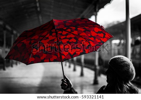 Woman silhouette holding red umbrella