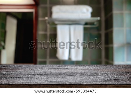Wood desk free space over bathroom background for product display. Business presentation