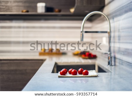 counter with fresh tomatoes and blurry kitchen background