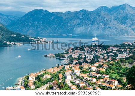 Panoramic view of port, town and mountains in Kotor, Montenegro Royalty-Free Stock Photo #593360963