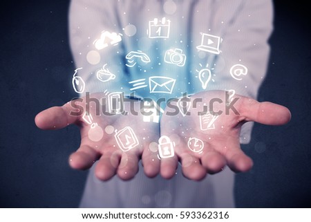 Blue multimedia icons in the hands of a businessman Royalty-Free Stock Photo #593362316