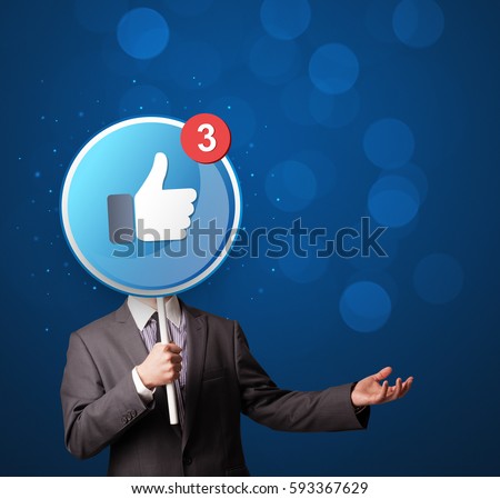 Smart businessman holding round sign with facebook like Royalty-Free Stock Photo #593367629
