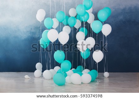 balloons on dark blue wall background. Colorful balloons in room prepared for birthday party.
