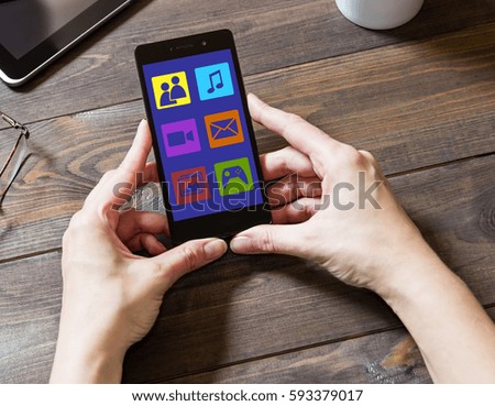 A woman uses social networks with a mobile phone. Icons of the social networking