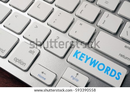 Keywords on a keyboard button. SEO concept.