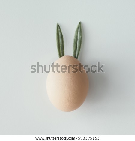 Easter egg with bunny ears. Flat lay. Minimal concept.