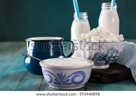 Dairy products on wooden table over blue background