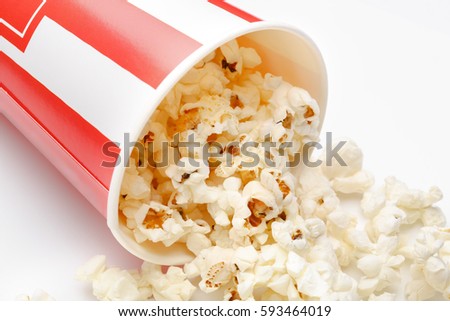 Popcorn in red and white cardboard box. Popcorn border isolated on white. Film. Fast food. Corn