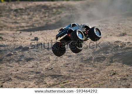 rc monster truck model with wheels in air Royalty-Free Stock Photo #593464292