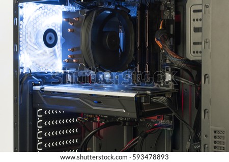 Close up view inside open midi tower computer case with red and blue lighting effects   Royalty-Free Stock Photo #593478893