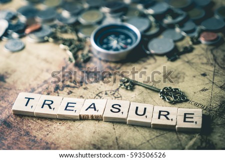 Vintage treasure hunting concept with coins and compass, for business wealth and success concept.