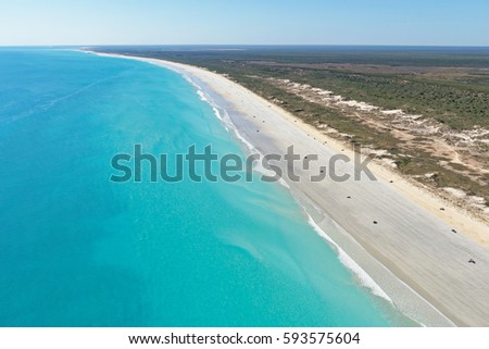Aerial view of cars dotted along the wide expanse of Cable Beach, Broome, Western Australia Royalty-Free Stock Photo #593575604
