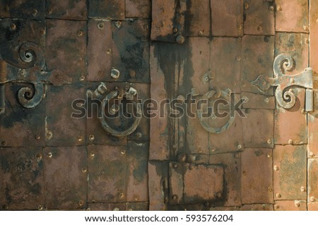 Old rusty iron door forged.