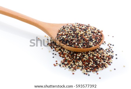 Quinoa seeds in wood scoop on white background