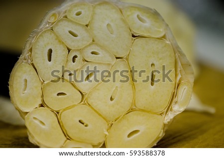 Garlic bulb sliced at the top before roasting in the oven for making roasted garlic. Royalty-Free Stock Photo #593588378