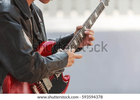 Musician playing electric guitar with nature light