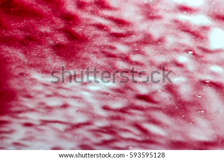 red blurred of drops of rain on glass. Background.